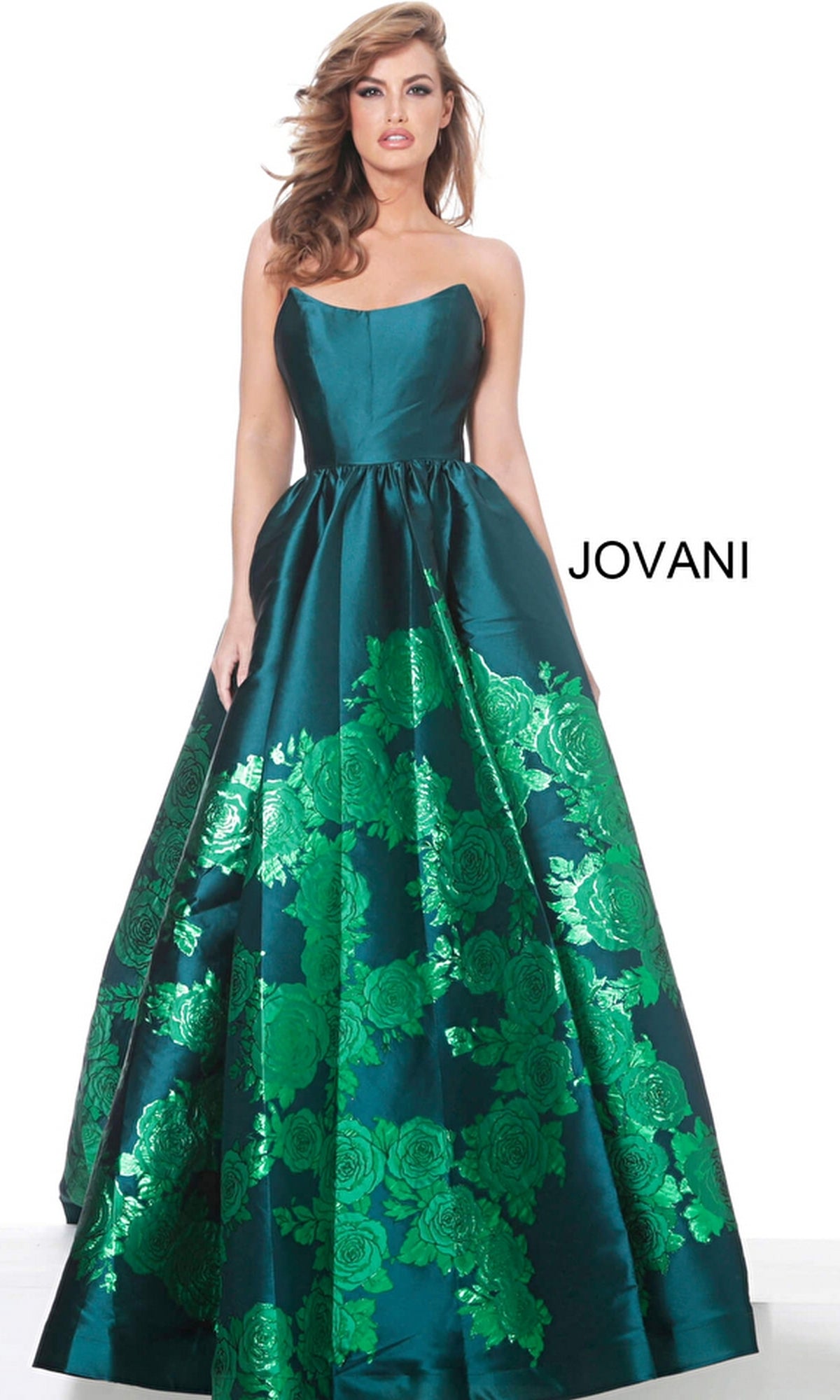 A woman in the Jovani Strapless Floral Long Prom Ball Gown 02038, an emerald green floral-print evening dress, poses against a white background with